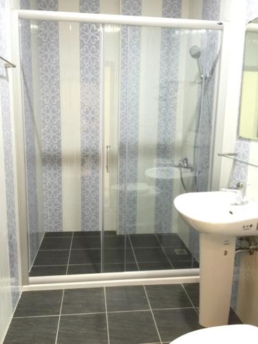 a bathroom with a shower and a sink at Slowly inn in Hengchun