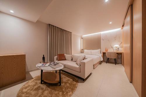 a hotel room with a bed and a couch at 신림 빌라드보니 villa de boni in Seoul
