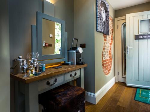 a bathroom with a vanity with a mirror and a sink at NoTwenty9 Bar and Restaurant in Burnham Market