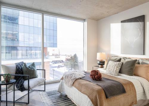 a bedroom with a bed and a large window at The Lakeview Guesthouse in Duluth