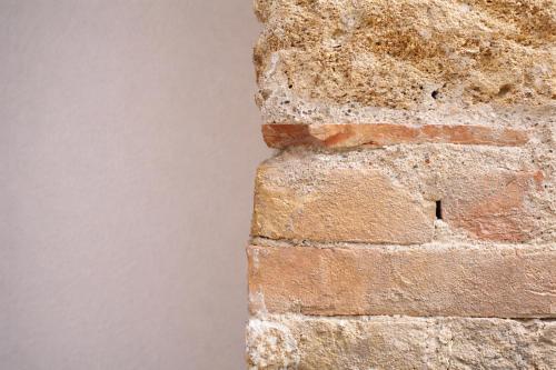 a brick wall with a hole in it at Hotel PI Arte Exclusive Suite in Palermo
