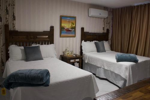 a hotel room with two beds with white sheets at Onyx luxury rd in La Romana