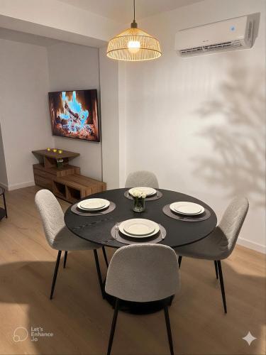 a dining room with a black table and chairs at Dulces Sueños Amistad in Valencia