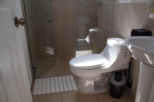 a bathroom with a shower and a toilet and a sink at Kirara's House in Chanmico
