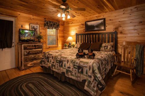 two children sitting on a bed in a cabin at Alpine Joy in Townsend