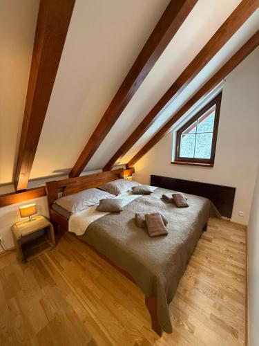 a bedroom with a large bed in a attic at Jezírko lesní restaurant & penzion in Jáchymov