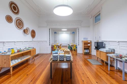 a large room with a table with food on it at HI Vila do Conde - Pousada de Juventude in Vila do Conde