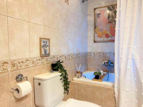 a bathroom with a toilet and a bath tub at Haplotēs Rhodes Studio in Koskinou