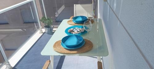 two hats on a table on a balcony at Luz del Mediterráneo in Moncófar