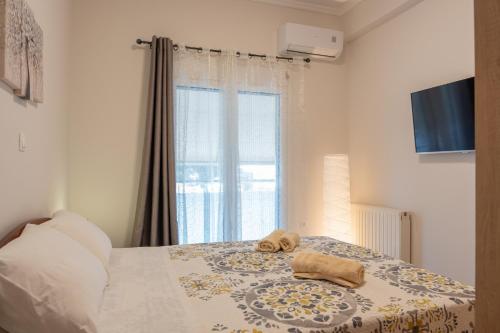 a bedroom with a bed with a towel on it at Artemida Beach Apartment 2 in Artemida
