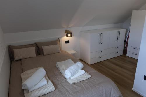 a bedroom with a large bed with two pillows at Mahne Apartment in Kranj