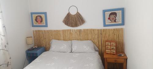 a bedroom with a bed with a wooden head board at Luz del Mediterráneo in Moncófar