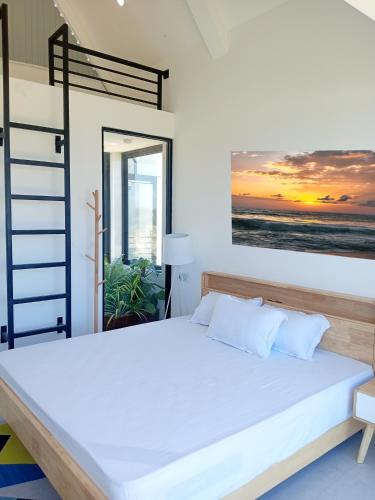 a bedroom with a bed and a view of the ocean at Pini Villa in Ampara