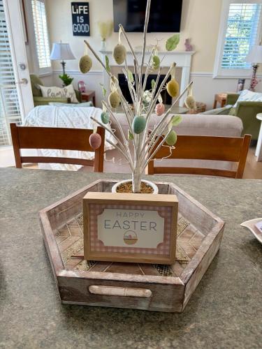 a vase with a happy easter sign on a table at Peaceful Oasis steps from Mohegan Sun in Norwich