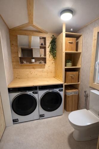 a laundry room with a washer and dryer at Juralodgespa Chalet Emma in Courrendlin