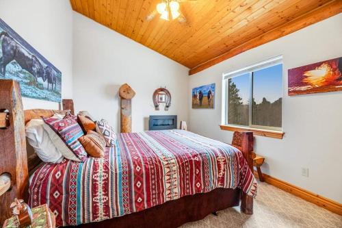 a bedroom with a bed and a window at Tetro Rock Retreat in Deadwood