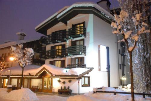 a large white building with snow on it at Hotel Les Jumeaux Courmayeur in Courmayeur
