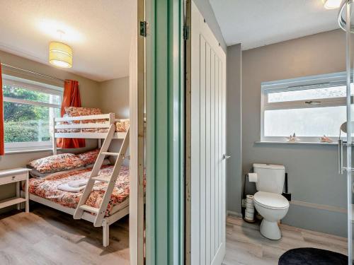 a small bedroom with two bunk beds and a toilet at 2 Bed in Swansea oc-90367 in Oxwich