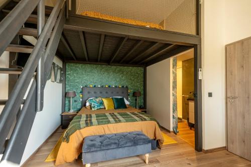 a bedroom with a large bed and a wooden floor at Chez Cécile et Marco in Moissac
