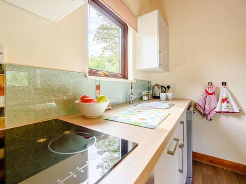 a kitchen with a counter with a sink and a window at 2 Bed in Pencader oc-89500 in Pencader