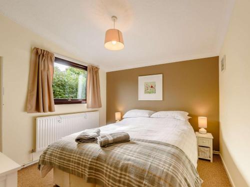 a bedroom with a large bed and a window at 2 Bed in Pencader oc-89500 in Pencader