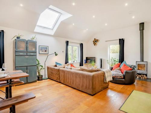a living room with a large couch and a skylight at 4 Bed in Llandysul oc-93546 in Henllan