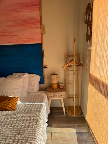 a bedroom with two beds and a table with a lamp at Hearttoart in Martigues