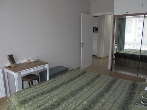 a bedroom with a bed and a desk and a mirror at bayern12 in Tbilisi City