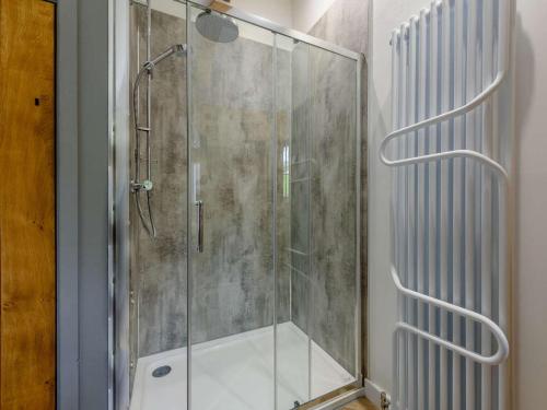 a shower with a glass door in a bathroom at 3 Bed in Llandysul oc-90019 in Llandyssiliogogo