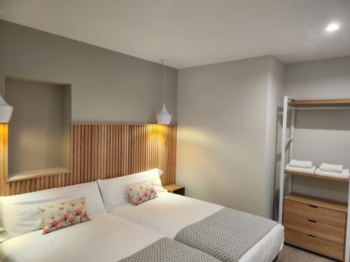 a bedroom with a white bed and a mirror at CREDENCIAL Bulevar in Sarria
