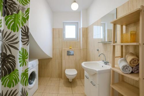 a bathroom with a sink and a washing machine at Ceglana Przystań na Kaszubach in Załakowo