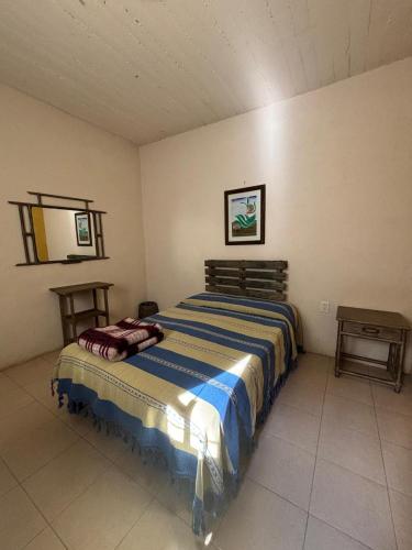 a bedroom with a large bed in a room at Tu casa Oaxaca... in Oaxaca City
