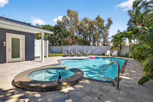 a swimming pool in the backyard of a house at Steps to beachTiki BarHeated Poolfun! in Clearwater Beach