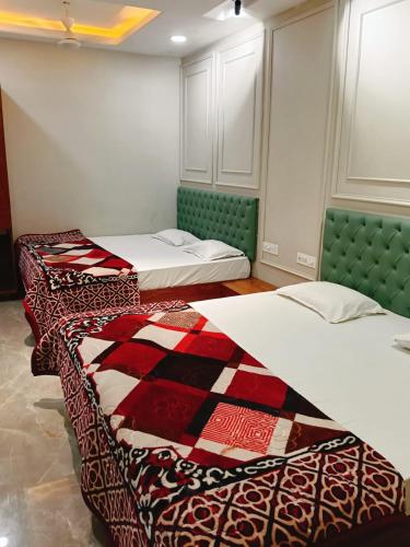 two beds sitting in a room with at Hotel Classio Ali Asgar in Jaorā