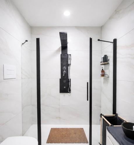 a shower with a glass door in a bathroom at Salerno casa con jacuzzi privata e cinema in Salerno