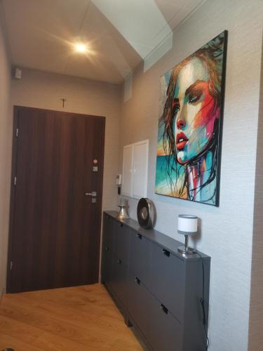 a room with a painting of a woman on the wall at Centro Residence in Kluczbork