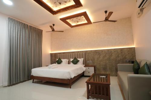 a hotel room with a bed and a couch at YR sea resort in Pāmban
