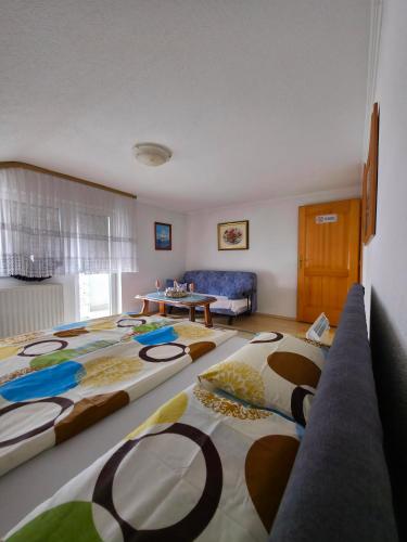 a living room with two large beds and a couch at Stan na dan Cazin in Cazin