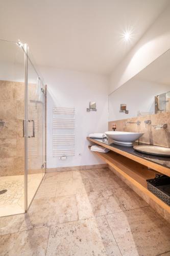 a bathroom with a sink and a shower at Ferienlandhaus Alpinum in Lenggries