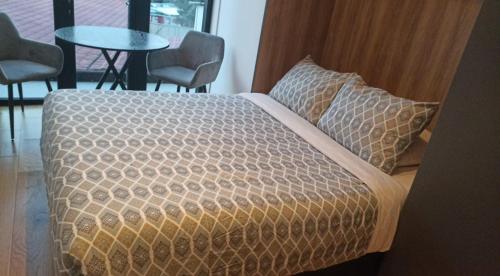 a bed in a room with a table and chairs at Mexico City loft in the heart of Roma Norte steps away from Cibeles in Mexico City
