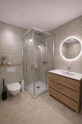 a bathroom with a shower and a toilet and a sink at Appartement vue mer Domaine Les Restanques Grimaud in Grimaud