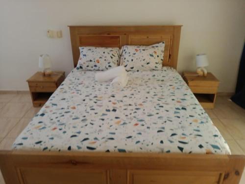 a bedroom with a large bed with a wooden frame at MK apartment in Las Terrenas