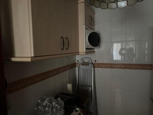 a kitchen with a sink and a microwave at Apartamento Torrox5 in Torrox Costa