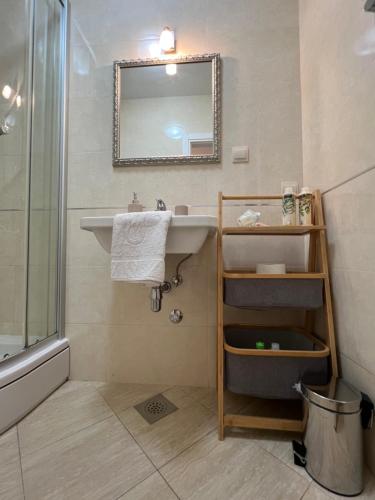 a bathroom with a sink and a mirror at Apartments Annette - studio and two bedroom apartment with parking in Dubrovnik