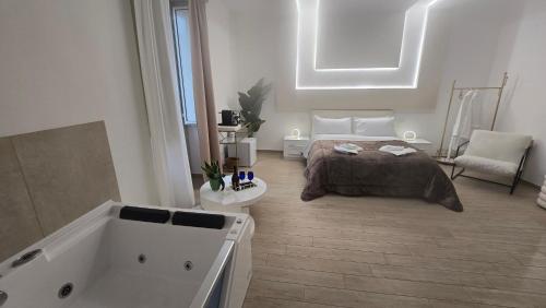 a bedroom with a bed and a bath tub at Centrale Suites in Brindisi