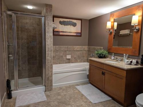 a bathroom with a tub and a shower and a sink at Mt. Slope Great View 1 Bed Condo in Vernon Township
