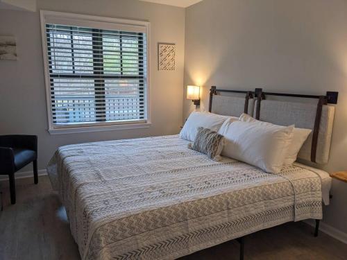 a bedroom with a large bed with a window at All New Chic Ski inout King bed in Vernon Township