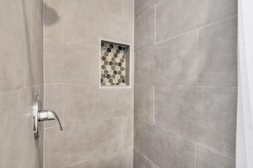 a bathroom with a shower with a glass door at Boutique Hotel Style Steps to Boardwalk in Seaside Heights