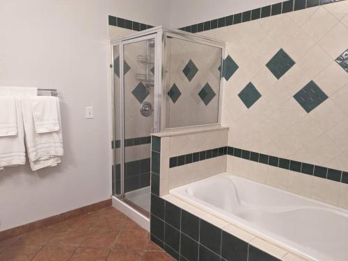a bathroom with a large tub and a shower at Country Chic New 2 Bed 2 Bath in Vernon Township