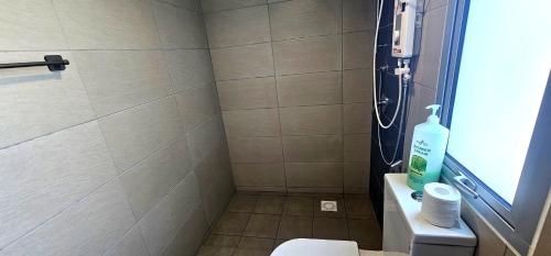 a bathroom with a shower with a toilet and a sink at Master Room with Private Bath at Kajang in Kajang